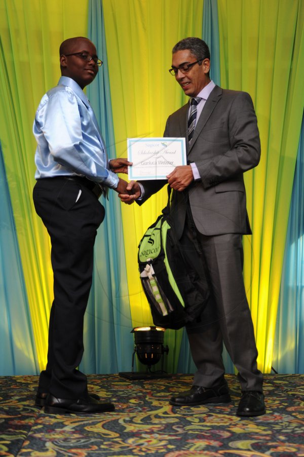 Ricardo Makyn/Staff Photographer
Richard Byles Presdent and Ceo  Sagicor presents   Gianluca Webster who will be attending Ardenne High School at the Sagicor annual GSAT awards ceremony at the Knutsford Court Hotel on Thursday 23.8.2012