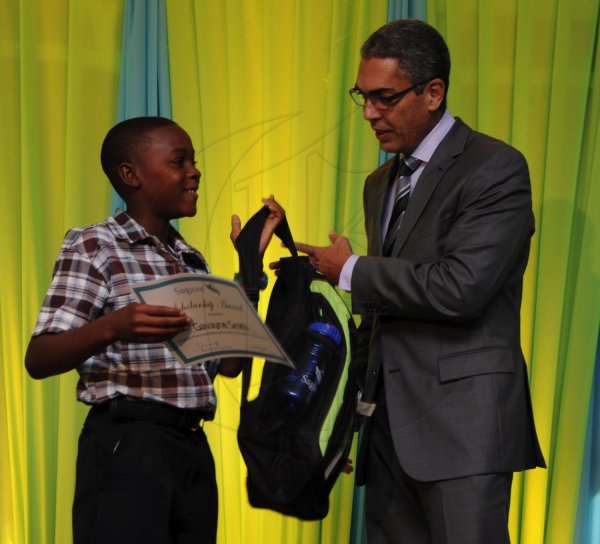 Ricardo Makyn/Staff Photographer
Richard Byles Presdent and Ceo  Sagicor presents Gavayne Smith   at the Sagicor annual GSAT awards ceremony at the Knutsford Court Hotel on Thursday 23.8.2012