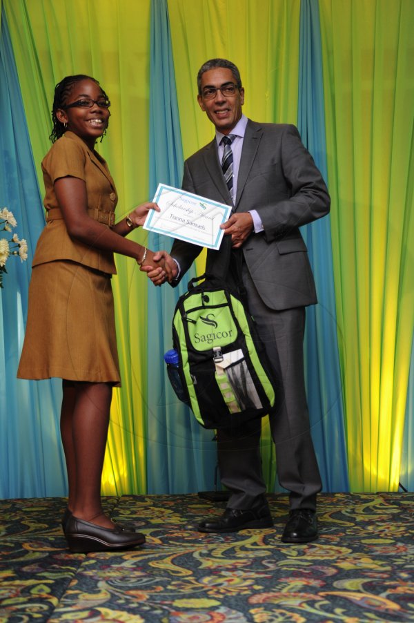 Ricardo Makyn/Staff Photographer
Richard Byles Presdent and Ceo  Sagicor presents Tianna Samuels who will be attending Campion  College  who will be attending Campion  at the Sagicor annual GSAT awards ceremony at the Knutsford Court Hotel on Thursday 23.8.2012