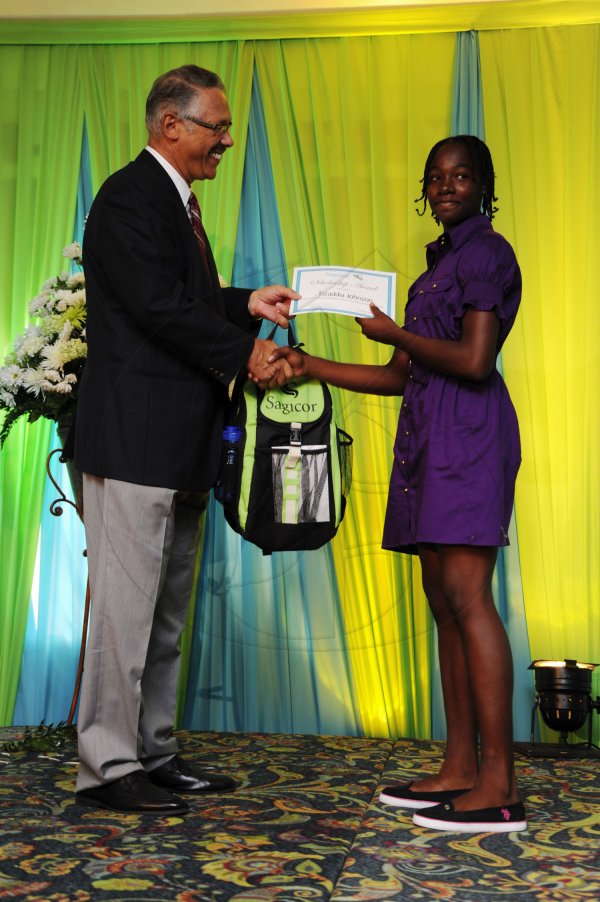 Ricardo Makyn/Staff Photographer
Errol McKenzie Executive Vice President Sagicor presents Tizaddia Johnson  at the Sagicor annual GSAT awards ceremony at the Knutsford Court Hotel on Thursday 23.8.2012