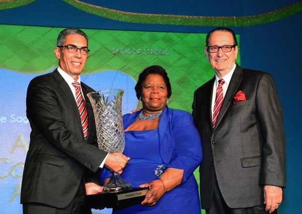 Winston Sill/Freelance Photographer
BUSINESS DESK:----- Sagicor Group Jamaica Annual Corporate Staff Awards Ceremony, held at the Jamaica Pegasus Hotel, New Kingston on Wednesday night march 12, 2014.  Here Richard Byles (left), President presents Mavis Ferguson (centre), Manager, Ocho Rios Branch with President's Trophy for Branch of the Year; at right is R. Danny Williams, Chairman.