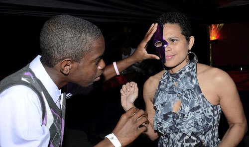 Rudolph Brown/Photographer
Kyle Nembhard, a patron attending the Sagicor Christmas party in New Kingston recently, appears to be testing the pulse of another patron, Tanya Miller, as he affixes a mask. Not clear whether the activities are related.


*************************************************************************-2011