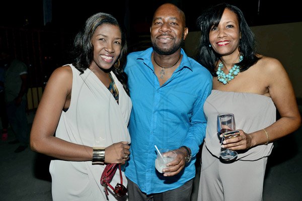 Rudolph Brown/Photographer
Karl Williams, Vice President Group Human Resources at Sagicor pose with Sancia Thompson, (left) and Michelle Distant at the Sagicor Christmas party at the Famous Night Club, in Portmore on Saturday, December 7, 2013