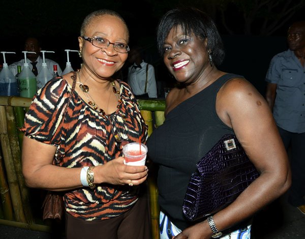 Rudolph Brown/Photographer
BUSINESS DESK
Gene Douglas, (left) and Janice Grant-Taffe at the Sagicor memba dis Christmas party at the office car park in New Kingston on Saturday, December 8-2012