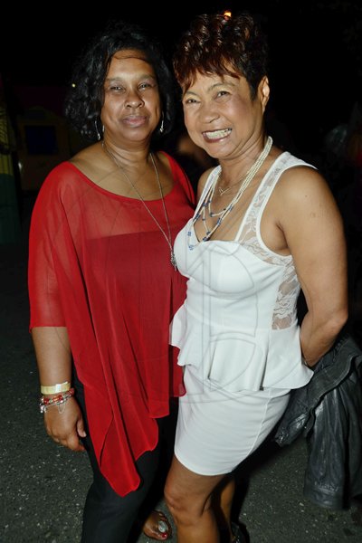 Rudolph Brown/Photographer
Lynette Chin-McDaniel, (right) and Audrey Flowers-Clarke  at the Sagicor memba dis Christmas party at the office car park in New Kingston on Saturday, December 8-2012