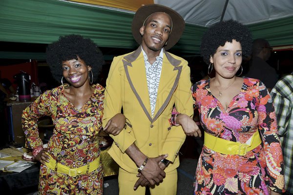 Rudolph Brown/Photographer
Jerome Vassell pose with Debra Barnes, (left) and Safiya Chisholm at the Sagicor memba dis Christmas party at the office car park in New Kingston on Saturday, December 8-2012