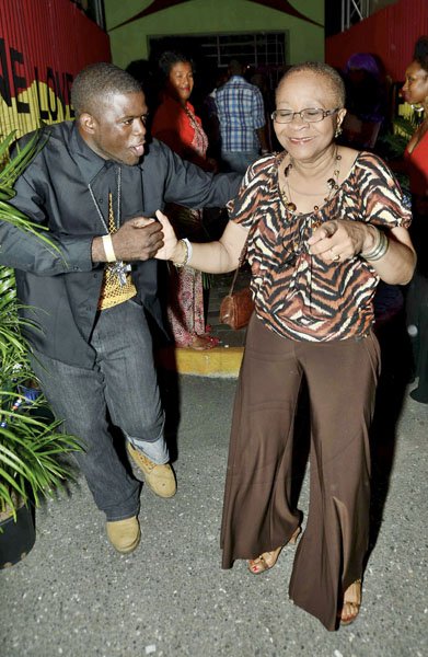 Rudolph Brown/Photographer
Gene Douglas, Director of Sagicor dance with Tamark Douglas at the Sagicor memba dis Christmas party at the office car park in New Kingston on Saturday, December 8-2012