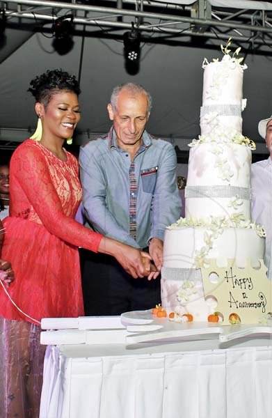 Ashley AnguinCouples Sans Souci's Entertainment Cordinator Nicola Barker cuts the anniversary cake with the resort groups CEO Glen Lawrence.