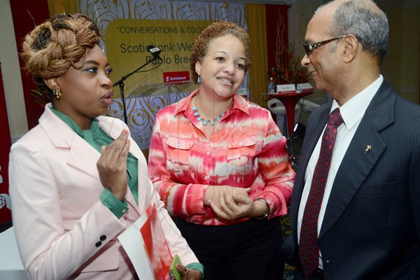 Rudolph Brown/Photographer
Wayne Powell, Scotiabank’s executive vice-president, Retail Banking chat with Wendy birthwright,(centre) scotiabank, product delivery manager and Doreen morris-thomas country manager for Magna Rewards at the Knutsford Court Hotel in New Kingston on Wednesday, May 15, 2013