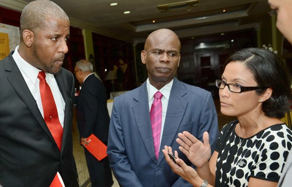 Rudolph Brown/Photographer
Steadman Fuller (centre), Custos of Kingston chat with Monique Todd and Dr. Wayne Henry at the Scotiabank Cocktails and Conversations panel discussion at the Knutsford Court Hotel in New Kingston on Wednesday, May 15, 2013