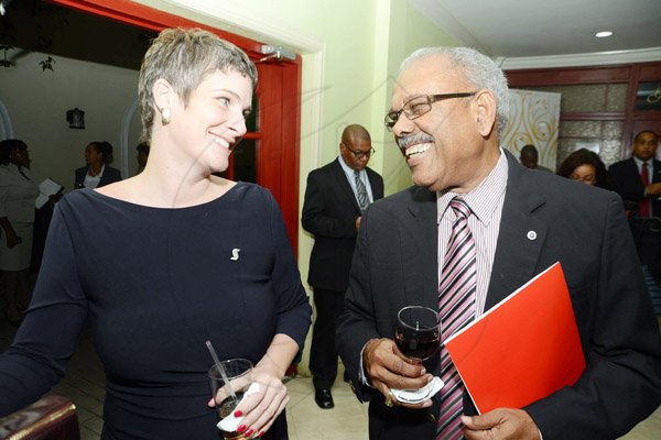 Rudolph Brown/Photographer
Geoffrey Messado, former managing director of General Accident warmly greets Debra Lopez Spence, director, Scotia Private Client Group at Scotiabank's cocktails and conversations panel discussion at the Knutsford Court Hotel, New Kingston on Wednesday.