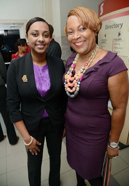 Rudolph Brown/Photographer
Suzan Sinclair, (right) Regional Sales Manager pose with Tessa Archie, Sales Advisor at the Ocho Rios branch Scotia Insurance 15th Anniversary cocktail forum on Tuesday, September 24, 2013