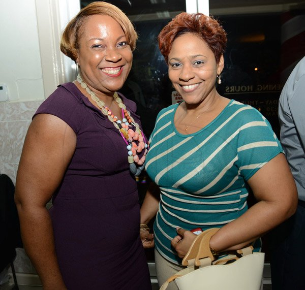 Rudolph Brown/Photographer
Suzan Sinclair, Regional Sales Manager pose with Colleen Hoilett at the Ocho Rios branch Scotia Insurance 15th Anniversary cocktail forum on Tuesday, September 24, 2013