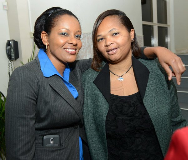 Rudolph Brown/Photographer
Paula Daye, (left) pose with Latoya Bryan at the Ocho Rios branch Scotia Insurance 15th Anniversary cocktail forum on Tuesday, September 24, 2013