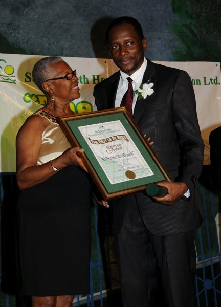 Winston Sill / Freelance Photographer
The St. Elizabeth Homecoming Foundation Limited (SEHF) 20th Annual Golden Awards Banquet, held at the Jamiaca Pegasus Hotel, New Kingston on Wednesday night November 28, 2012. Here are Phyll Williams (left); presenting to DiMario McDowell (right),  for The Arts.