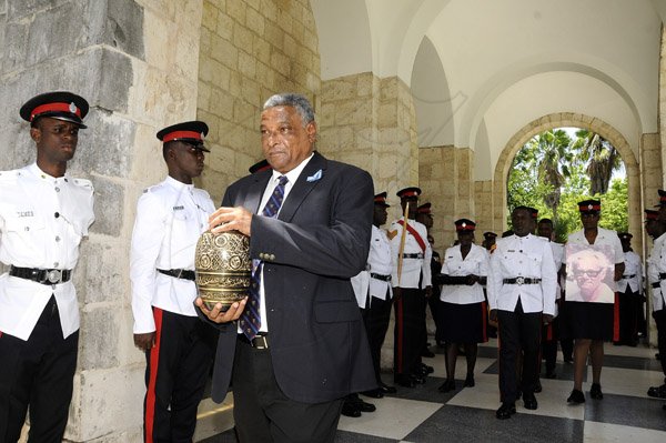 Gladstone Tayor /  Photographer

Norman Manley (son) carries the urn out of the chapel as seen at the funeral Service of Dr. Douglas Ralph Manley, CD held at the UWI Mona Chapel yesterday morning