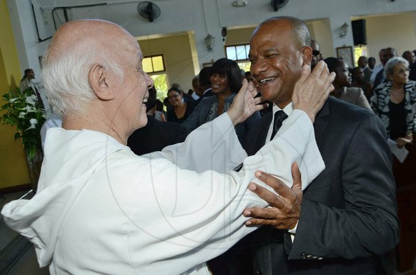 Rudolph Brown/Photographer
Father HoLung greets Minister Peter Bunting, after the funeral service for his mother Pauline Bunting at Sts. Peter and Paul Catholic Church on Monday, April 22, 2013