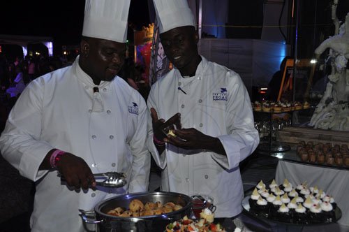 Janet Silvera Photo
Kingston's newest corporate executive chef all the way from Jamaica's north coast, Mark Cole (left) now managing all three Hendrickson kitchens at the Jamaica Pegasus, checking out his dessert station with pastry chef, Anthony Walters at Shaggy and Friends at Jamaica House last Saturday night.