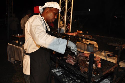 Janet Silvera Photo
VIP Meats' Dwayne Dyer roasting prime cuts of lamb, served with sorrel chutney at Shaggy and Friends at Jamaica House last Saturday night.
