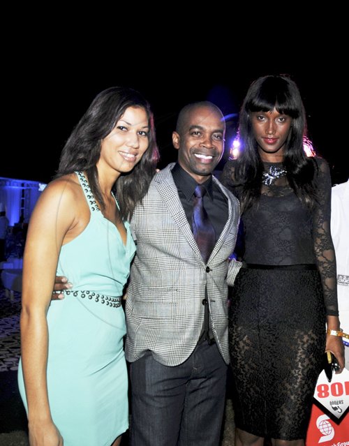 Contributed
Jamaican supermodel Jaunel McKenzie (right), and beau David Annakie (center) of  Jamrock Magazine, celebrate with Flow's Nicole Campbell (left) after McKenzie's successful bid  for an electric guitar in the charity auction at the Shaggy and Friends concert. Proceeds from the event which was held on the lawns of Jamaica House on January 7, were in aid of the Bustamante Children's Hospital.