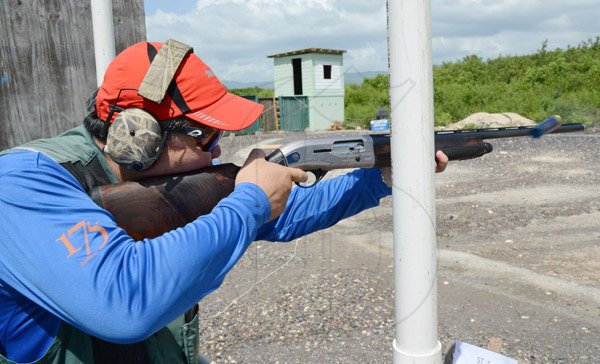 Rudolph Brown/Photographer
Robert Yap shooting at his target at Bernard Cridland Memorial Sporting Clay Shooting competition at the Jamaica Skeet Club on Sunday, October 27, 2013