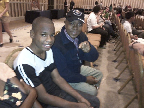 A confident Gifton Wright (left), The Gleaner's Children's Own Spelling Bee champion, and his coach, Reverend Glen Archer at the Scripps National Spelling Bee Orientation yesterday in Maryland, United States. The competition begins today with a computer spelling test, oral rounds tomorrow and then the semi-finals and finals on Thursday. This year, 278 spellers will compete for the championship.