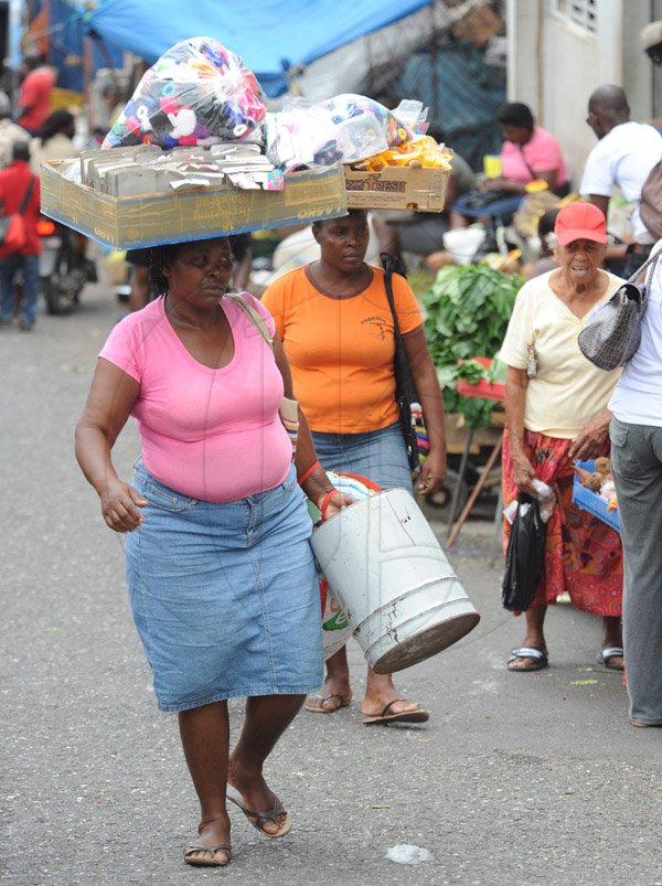 Jermaine Barnaby/Photographer
These two vendors were seen making their way to the St Ann's bay arcade during a tour of parish capital, St Ann's Bay on Saturday March 21, 2014.