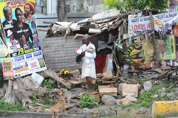 Jermaine Barnaby/Photographer
A woman outside a shack on Windsor road St Ann's bay during a tour of parish capital, St Ann's Bay on Saturday March 21, 2014.