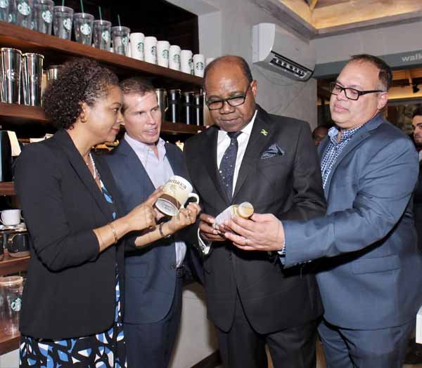 Ashley Anguin PhotoMinister of Tourism, Edmund Bartlett (2nd right) and Attorney General, Marlene Malahoo-Forte checks out the Starbucks products at the first store at the Doctor's Cave in Montego Bay, with Adam Stewart (2nd left) and Ian Dear *** Local Caption *** Ashley Anguin PhotoMinister of Tourism, Edmund Bartlett (2nd right) and Attorney General, Marlene Malahoo-Forte checks out the Starbucks products at the first store at the Doctor's Cave in Montego Bay, with Adam Stewart (2nd left) and Ian Dear