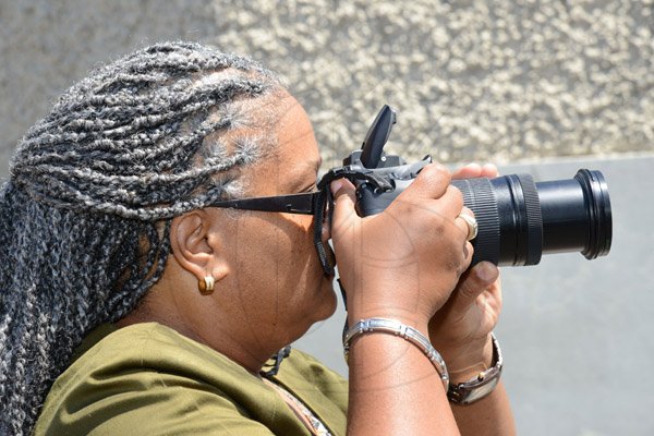 Ricardo Makyn/Staff Photographer 
Sharon Hay Webster  snaps away with Her Camera at the  state opening of Parliament at Gordon House on Thursday 3.4.2014