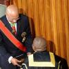 Ricardo Makyn/Staff Photographer 
Governor General of Jamaica His Excellency Sir Patrick Allen  receiving the throne speech from Floyd Morris  before  giving the throne speech at the state opening of Parliament at Gordon House on Thursday 3.4.2014