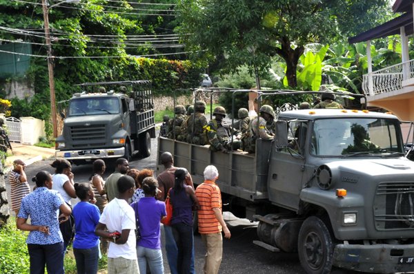 Norman Grindley/ChiefPhotographer
Members of the Jamaica Defence Force heads out of Sterling Castle in Upper St. Andrew May 27, 2010 after an operation in the area.