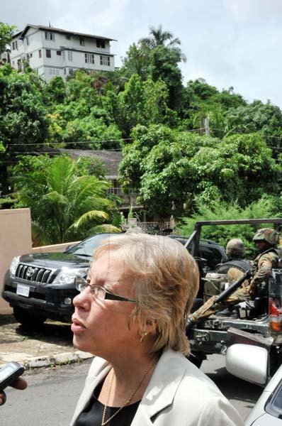 Norman Grindley/ChiefPhotographer
Human-rights activist Carolyn Gomes speaks to journalists as the house where Keith Clarke lived looms large in the background.

Military operation in Sterling Castle in Upper St. Andrew May 27, 2010.