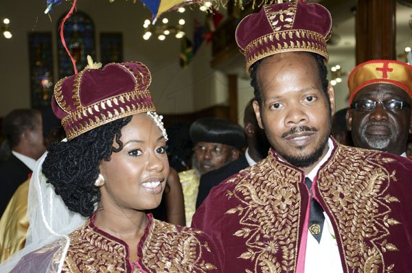Rudolph Brown/Photographer
Steven Golding son of Prime Minister Bruce Golding and his bride Emprezz, exit the University Chapel dressed in traditional African royal robes, after their wedding ceremony yesterday.