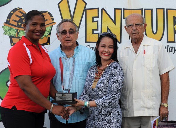 Ian Allen/Photographer
Owners of Abbey Road collecting the trophy after winning  Top Draw "Million Jackpot Every Day" Trophy for 3-Y-O over 1700 metres at Caymanas Park on Boxing Day.