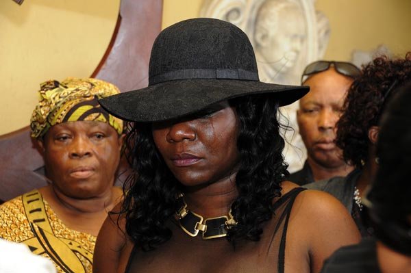 Gladstone Taylor  / Photographer

Tears rolled down the cheeks of Carmelita Burrel (wife) as she stood before the coffin of her late husband Philip Burrel


Thanksgiving Service for the life of Philip "Fattis" Burrell held at the Holy Trinity Cathedral, 1-3 George Headley Drive, Kingston on Saturday December 17, 2011