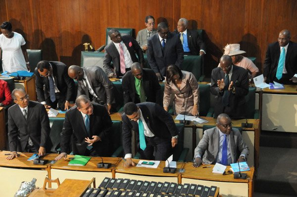 Jermaine Barnaby/Freelance Photographer
Government members stand to applaud the governor generals throne speech presentation at the state opening of Parliament at Gordon House on Thursday April 14, 2016.