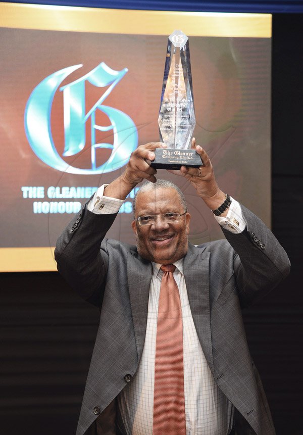 Jermaine Barnaby/Photographer
Dr. Peter Phillips hold aloft the Gleaner Honour awards for man of the year held at the Pegasus hotel on Monday January 25, 2016.