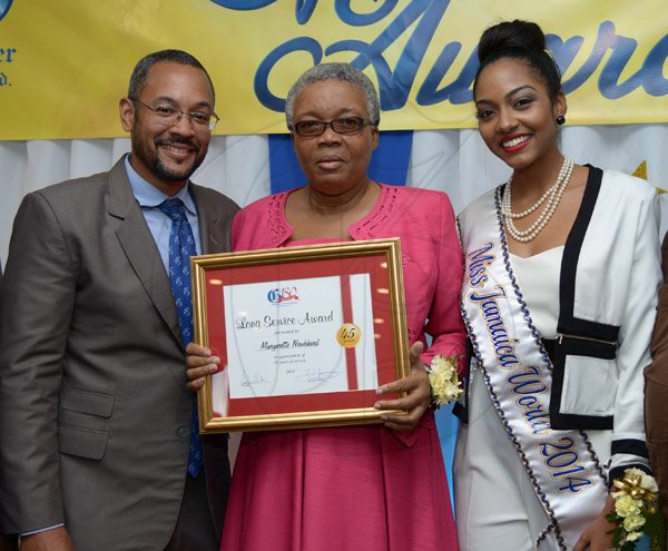 Ian Allen/Photographer
Margarette Nembhard centre,  pose with Christopher Barnes left, Managing Director, Gleaner Company and Laurie-Ann Chin right, Miss Jamaica 2014 shortly after she awarded for completing 45 years of service to the Gleaner during thier Long Service Awards Ceremony at the Jamaica Pegasus Hotel in Kingston on Tuesday.