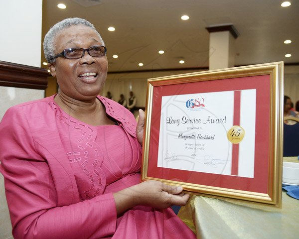 Ian Allen/Photographer
Margarette Nembhard who pose with the plaque she got for completing 45 years of service to the Gleaner during thier Long Service Awards Ceremony at the Jamaica Pegasus Hotel in Kingston on Tuesday.