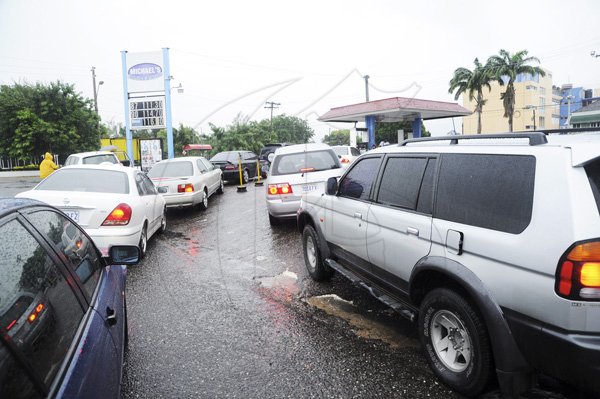 Ricardo Makyn/Staff Photographer
Motorist queue to fill up their tanks at Michael service station on Duke Street as Tropial Storm Sandy approaches Jamaica