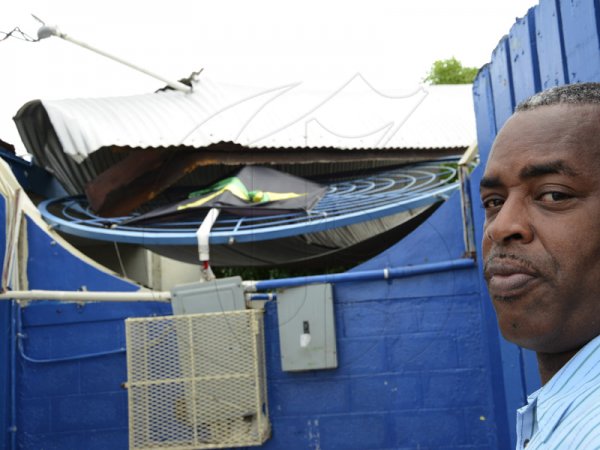 Rudolph Brown/Photographer
Vice-principal of Naggo Head Primary Errol Duncan shows the only damage to the school after Hurricane Sandy passed through.

 Jamaica on damage properties on Thursday, October 25, 2012