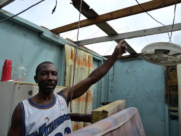 Rudolph Brown/Photographer
Kenneth Kepple shows what's left of his roof after Hurricane Sandy passed through Christian Pen on damage properties on Thursday, October 25, 2012