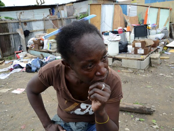 Rudolph Brown/Photographer
Claudette Berry contemplates her next move after her house was blown down by Hurricane Sandy after it passed through on Wednesday.

 Jamaica on damage properties on Thursday, October 25, 2012