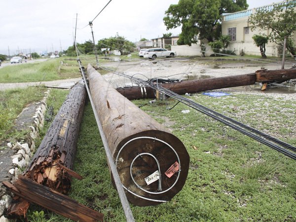 Anthony Minott/Freelance Photographer
A downed Utility pole in Braeton, Phase one, during the passage of Hurricane Sandy in Portmore, St Catherine last Thursday.