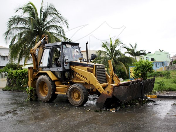 Anthony Minott/Freelance Photographer
A tractor removes debris from a road in Greater Portmore after the passage of Hurricane Sandy in Portmore, St Catherine last Thursday.