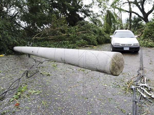 Ricardo Makyn/Staff Photographer
A fallen pole on the Stony Hill main road St Andrew