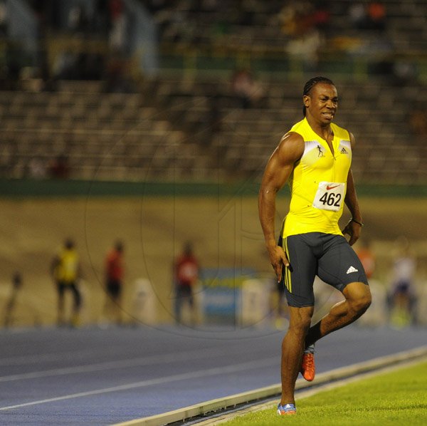 Ricardo Makyn/Staff Photographer 
 From left Dwight White of GC Foster College,Kim Collins race ahead as Yohan Blake pulls up while feeling cramps in the Men's  100 Meter    at the Utech Classic's held at the National stadium on Saturday 13.4.2013