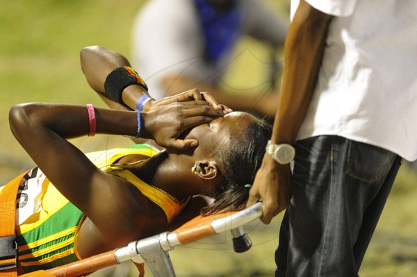 Ricardo Makyn/Staff Photographer 
 A devastated Shericka Jackson after getting injured   at the Utech Classic's held at the National stadium on Saturday 13.4.2013