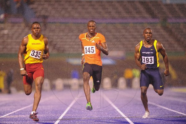 Ricardo Makyn/Staff Photographer.
Odean Skeen of Wolmers beating Andre Wellington and Barnes   at the Utech Classics held at the National Stadium on Saturday 15.4.2012